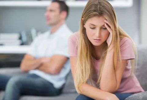 Couple not talking after a fight on the sofa in living room at home