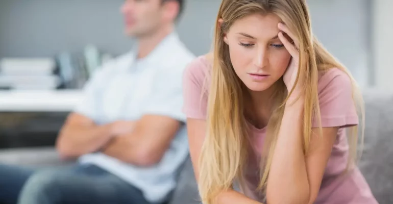 Couple not talking after a fight on the sofa in living room at home